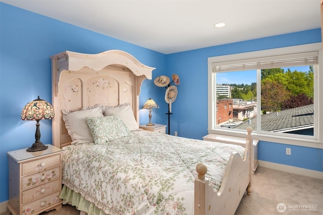 carpeted bedroom featuring baseboards