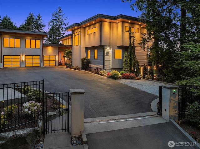 209 Northside Rd, Bellevue, WA 98004 - contemporary home featuring a gate, asphalt driveway, a fenced front yard, and an attached garage