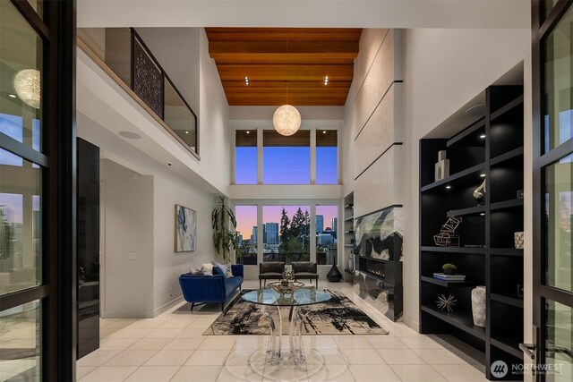 209 Northside Rd, Bellevue, WA 98004 - living area with a high ceiling, light tile patterned flooring, baseboards, a skyline view, and wooden ceiling