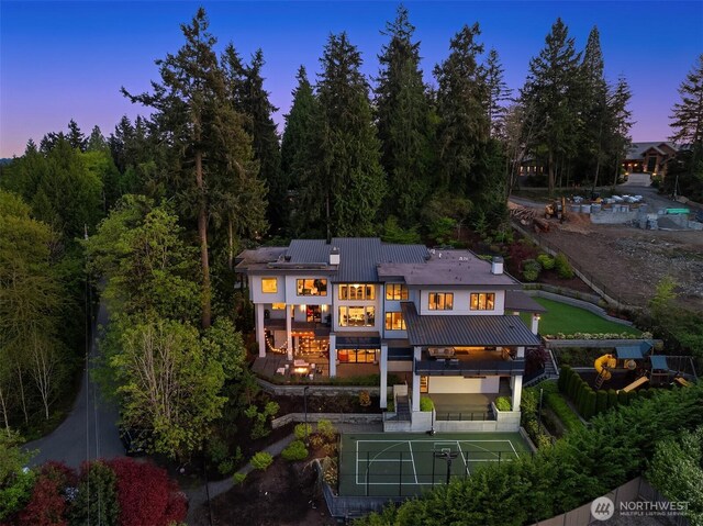 209 Northside Rd, Bellevue, WA 98004 - back of property at dusk featuring a balcony and metal roof