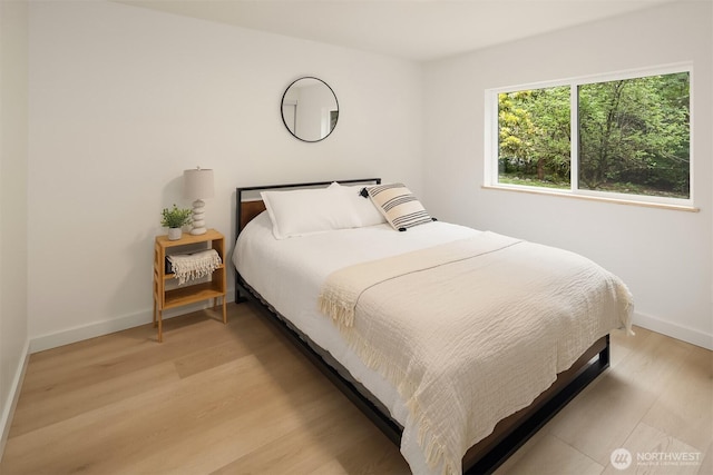 bedroom featuring baseboards and light wood-type flooring
