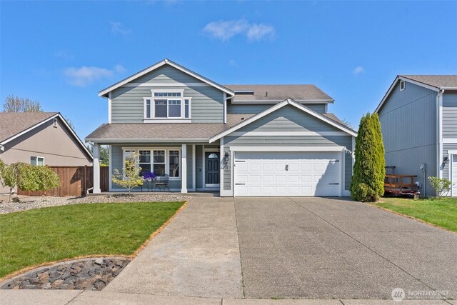 traditional-style home featuring a porch, driveway, roof with shingles, a front yard, and an attached garage