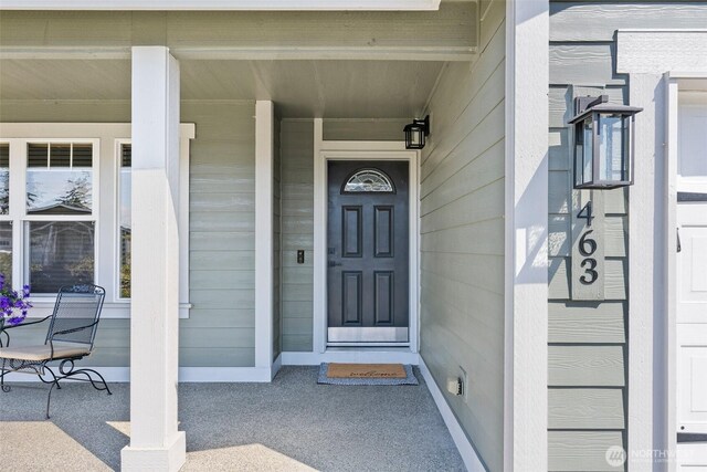 view of exterior entry featuring a porch