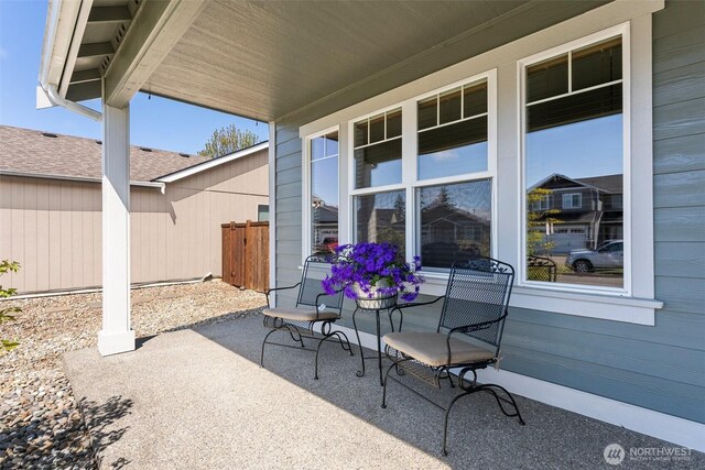 view of patio featuring fence and covered porch
