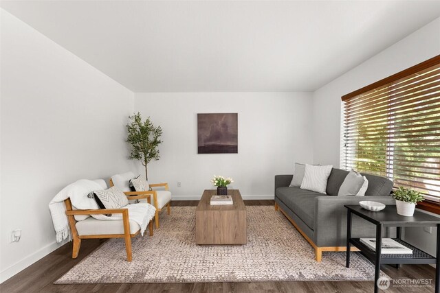 living room featuring baseboards and wood finished floors