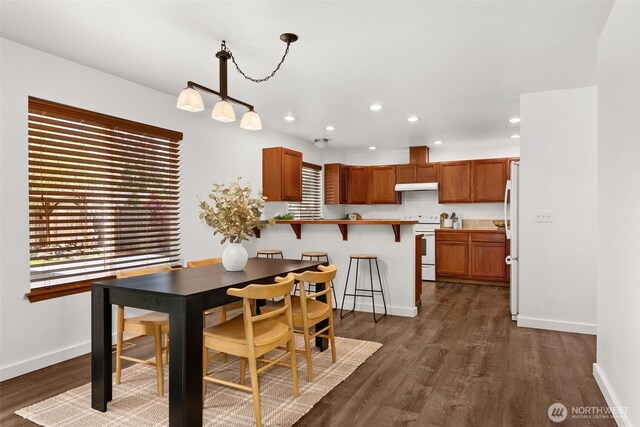 dining area featuring baseboards, recessed lighting, and dark wood-style flooring