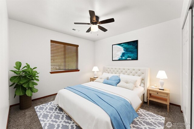 carpeted bedroom with baseboards, ceiling fan, and visible vents