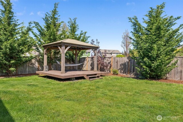 view of yard with a gazebo, a fenced backyard, and a deck