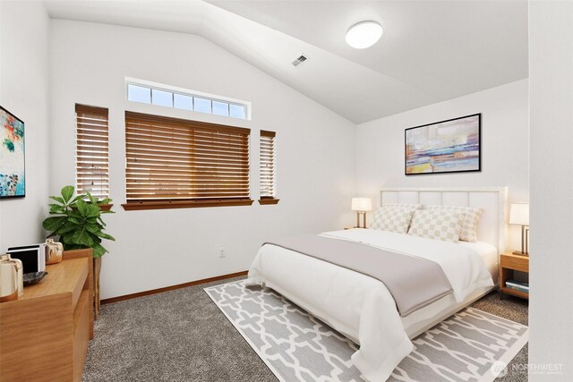 carpeted bedroom with baseboards, vaulted ceiling, and visible vents
