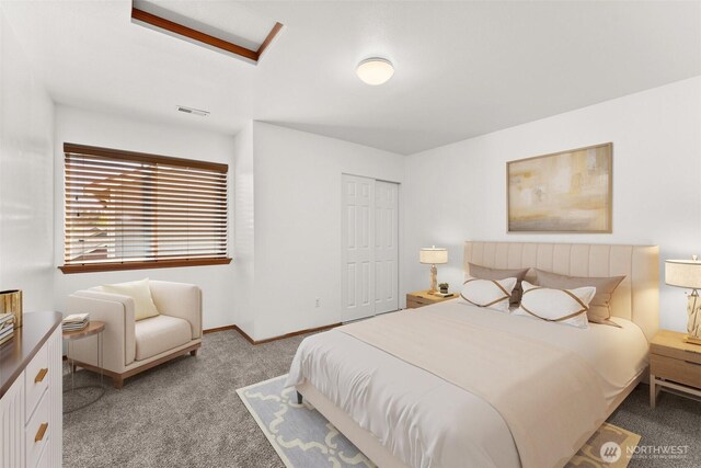 carpeted bedroom with baseboards, a closet, and visible vents