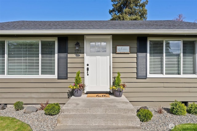 property entrance with a shingled roof