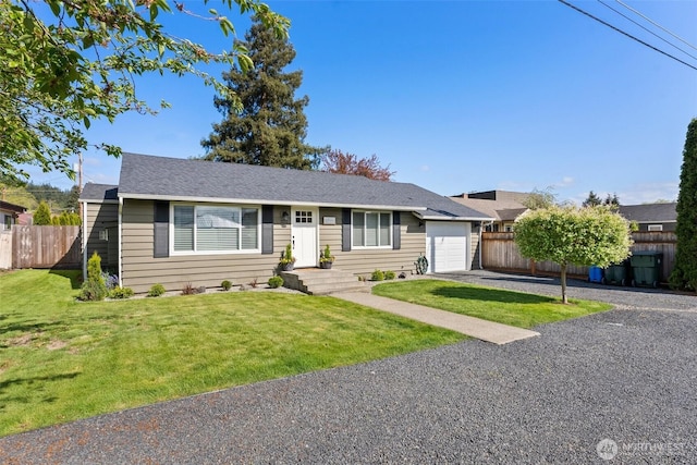 ranch-style home featuring fence, a front yard, driveway, and a garage