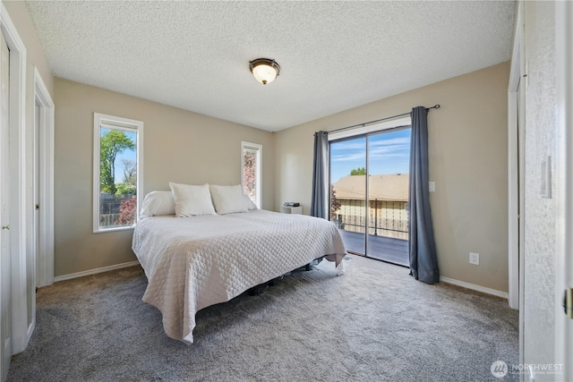 carpeted bedroom featuring baseboards, a textured ceiling, and access to exterior