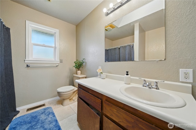 full bath with vanity, a textured wall, toilet, and visible vents