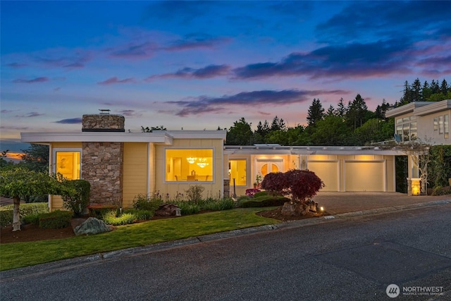 5310 143rd Ave SE, Bellevue, WA 98006 - view of front facade featuring a garage, driveway, stone siding, and a chimney
