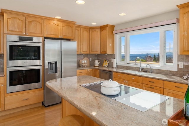 5310 143rd Ave SE, Bellevue, WA 98006 - kitchen featuring appliances with stainless steel finishes, a sink, light stone countertops, backsplash, and recessed lighting