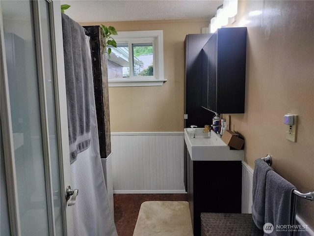 21926 Vashon Hwy SW, Vashon, WA 98070 - full bath with a shower with shower curtain, wainscoting, vanity, and baseboards