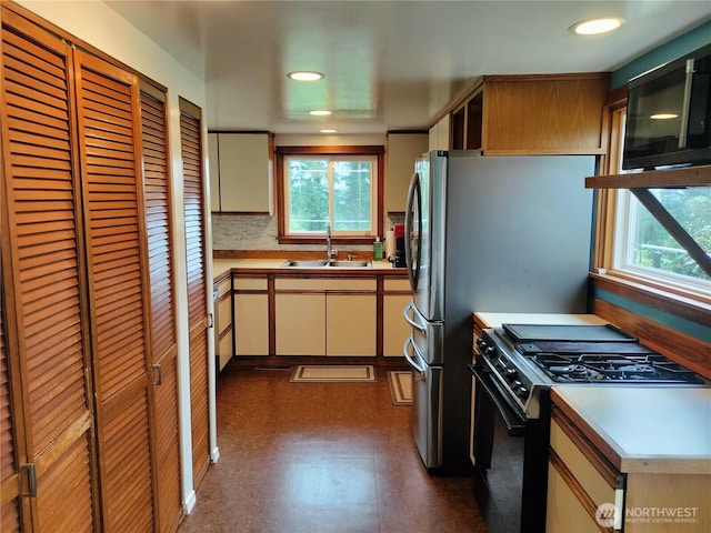 21926 Vashon Hwy SW, Vashon, WA 98070 - kitchen featuring black appliances, a sink, plenty of natural light, light countertops, and recessed lighting