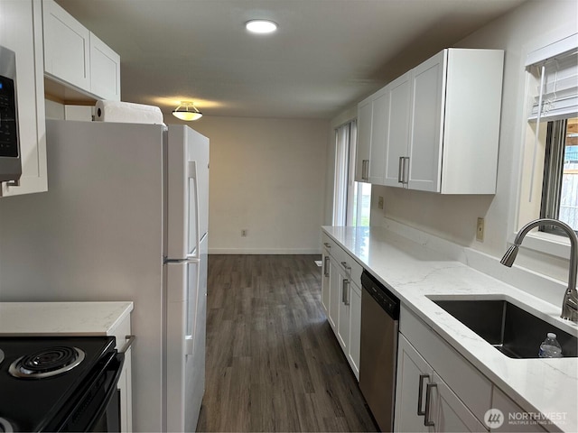 1615 S 90th St, Tacoma, WA 98444 - kitchen featuring light stone countertops, baseboards, dark wood-style floors, a sink, and stainless steel appliances
