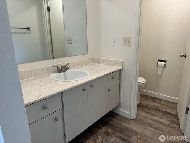1615 S 90th St, Tacoma, WA 98444 - bathroom with vanity, baseboards, wood finished floors, and toilet