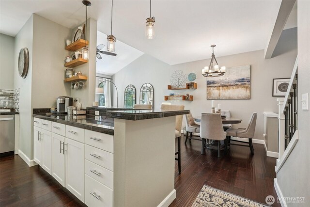 kitchen with a peninsula, open shelves, dark wood finished floors, and white cabinets