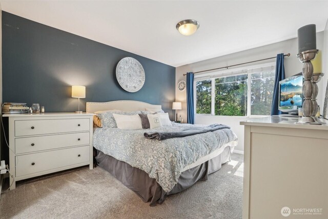 bedroom featuring light carpet