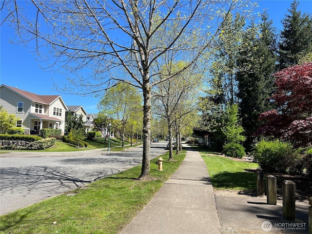 view of asphalt road featuring sidewalks