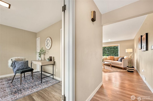 interior space with visible vents, baseboards, and wood finished floors