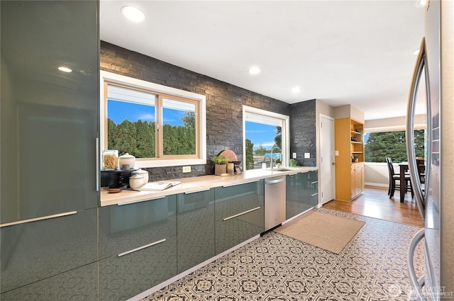 bar with stainless steel appliances, recessed lighting, a sink, and light floors