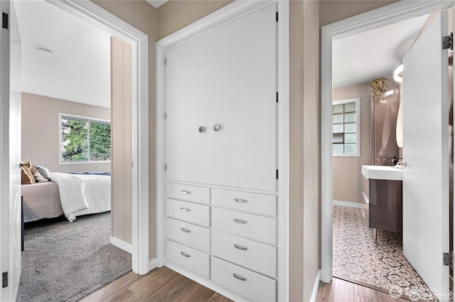 hallway with baseboards and wood finished floors
