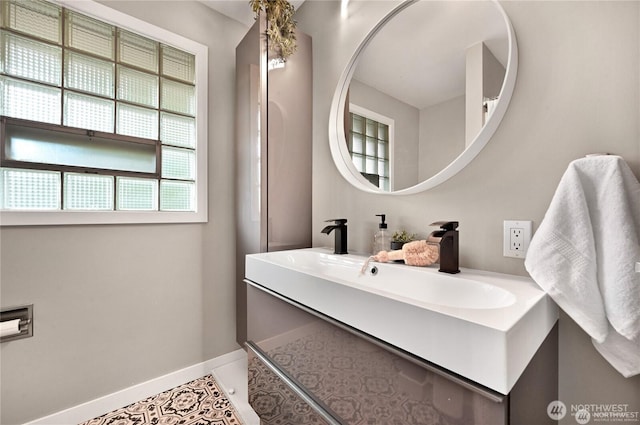 bathroom with baseboards, tile patterned flooring, and vanity