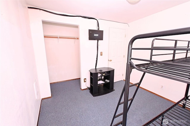 carpeted bedroom with baseboards and a closet