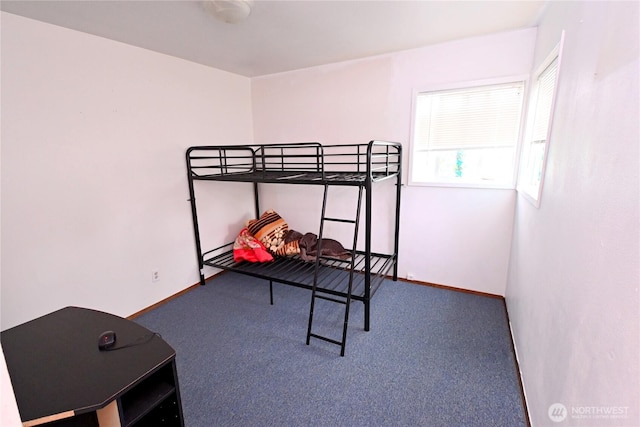 carpeted bedroom with baseboards