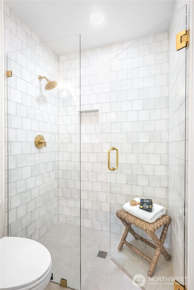 full bath featuring toilet and tiled shower