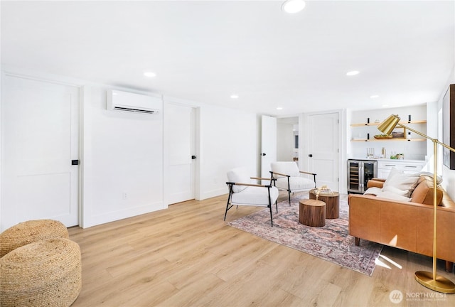living area featuring an AC wall unit, light wood-style floors, recessed lighting, and wine cooler
