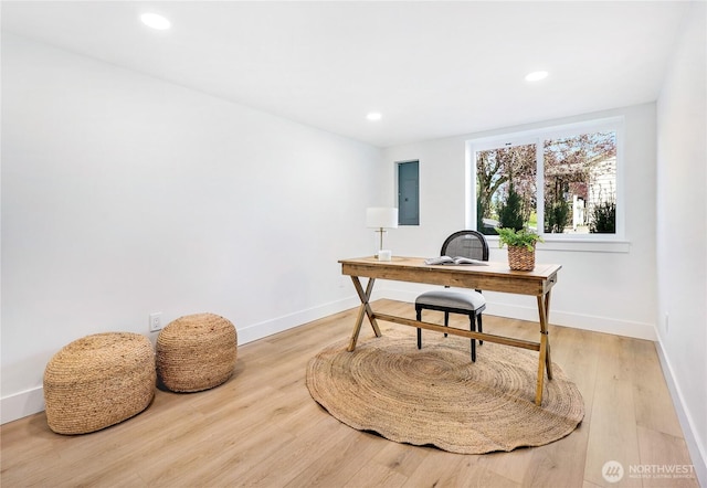 office space featuring recessed lighting, baseboards, and light wood-style floors