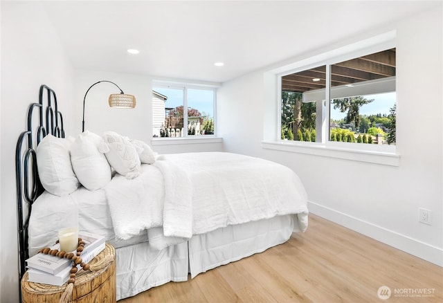 bedroom with baseboards, recessed lighting, and wood finished floors