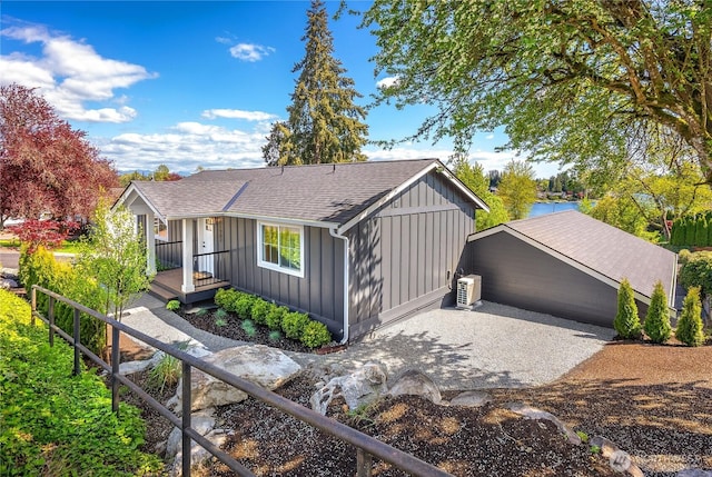ranch-style house featuring board and batten siding and roof with shingles