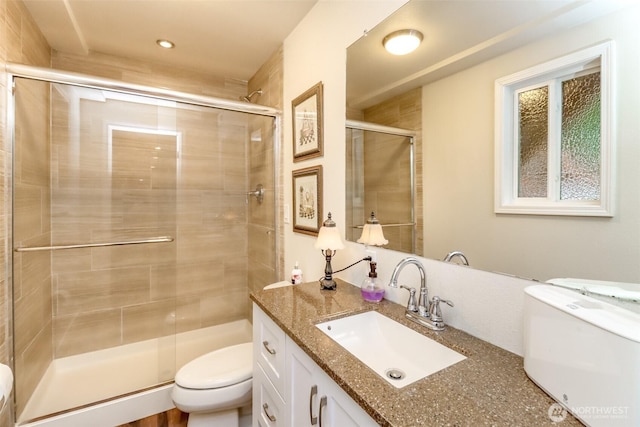 full bathroom with vanity, recessed lighting, toilet, and a shower stall