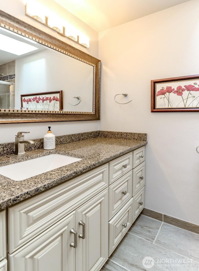 bathroom with baseboards and vanity