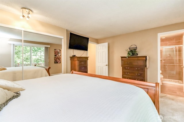 bedroom with carpet flooring and connected bathroom