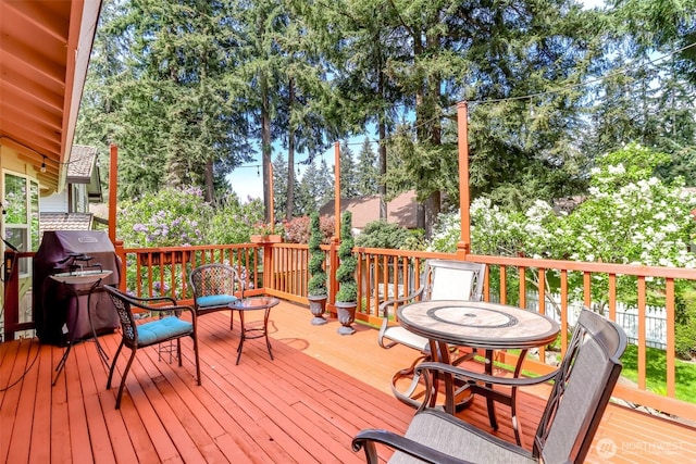 wooden deck with a grill