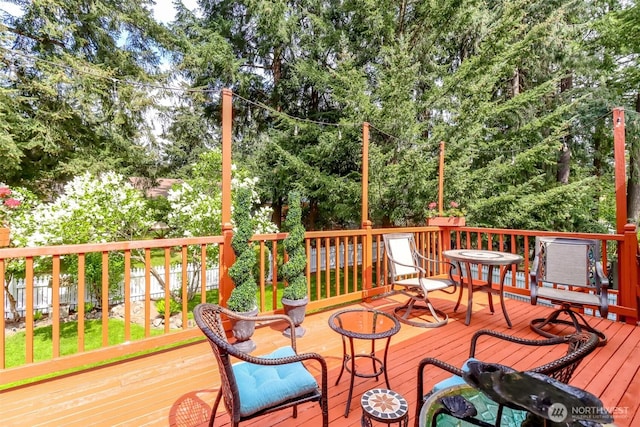 wooden terrace with an outbuilding, a fenced backyard, and a shed