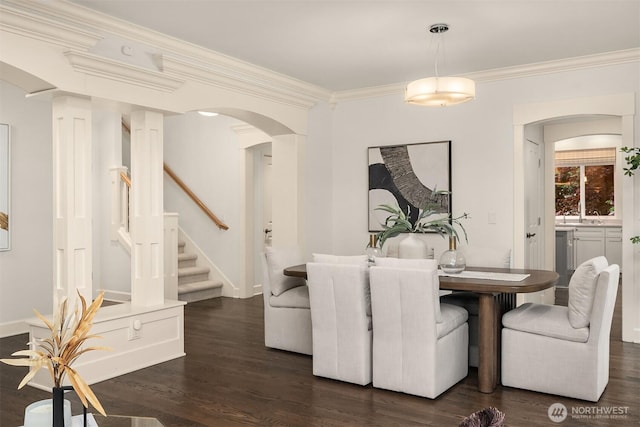 325 6th Ave S, Kirkland, WA 98033 - dining area with dark wood-style flooring, arched walkways, baseboards, ornamental molding, and stairs
