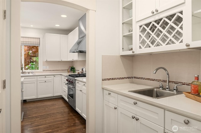 325 6th Ave S, Kirkland, WA 98033 - kitchen featuring wall chimney range hood, white cabinets, a sink, stainless steel stove, and tasteful backsplash