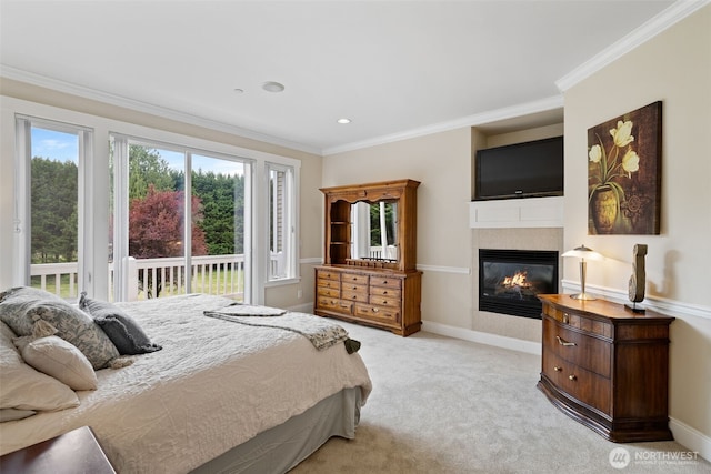 bedroom featuring light colored carpet, a glass covered fireplace, access to exterior, baseboards, and ornamental molding