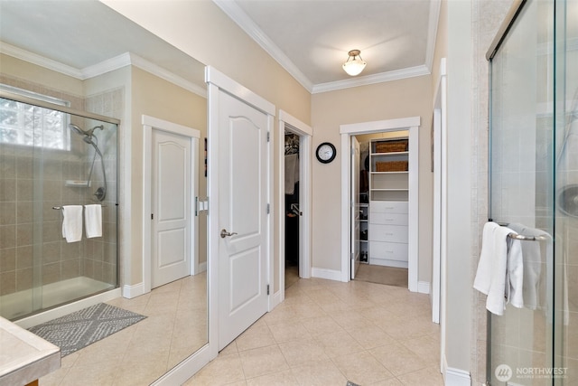 full bath with crown molding, a walk in closet, and a shower stall