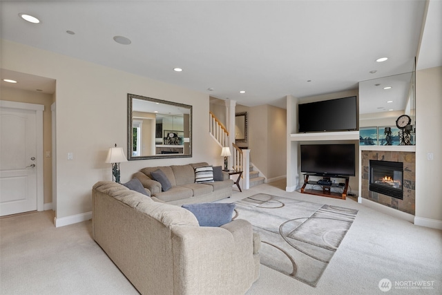 living area with baseboards, stairway, light colored carpet, recessed lighting, and a tile fireplace
