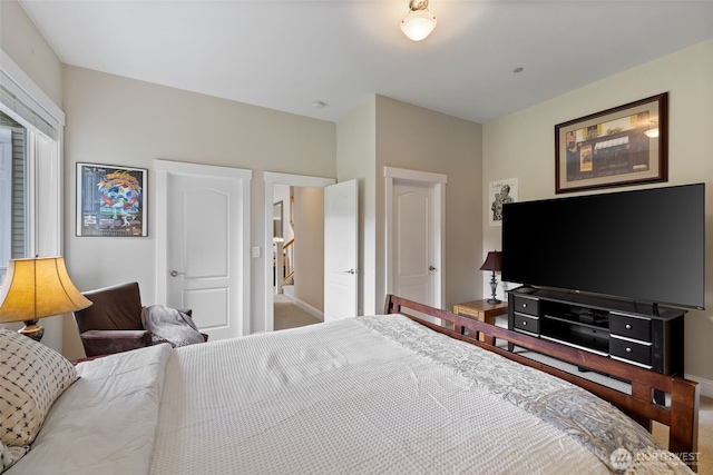 bedroom featuring carpet floors and baseboards
