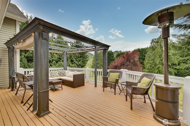 wooden deck featuring an outdoor living space and a pergola